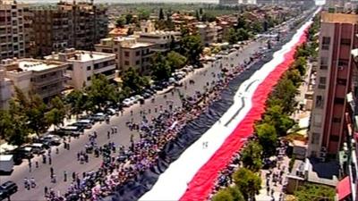 2000ft Syrian flag being held up by supporters of President Assad