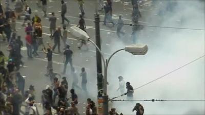 Demonstrators in a cloud of teargas