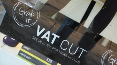 Shop window sign offering VAT cut