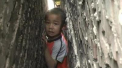 A boy trapped between two brick walls in China