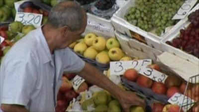 Man at greengrocer's stall
