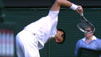 Novak Djokovic smashes his racquet