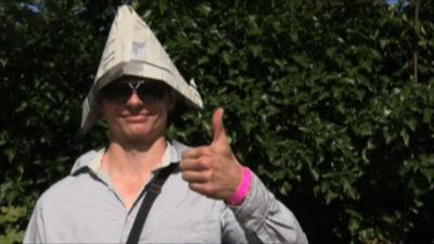 A Wimbledon fan soaks up the sunshine