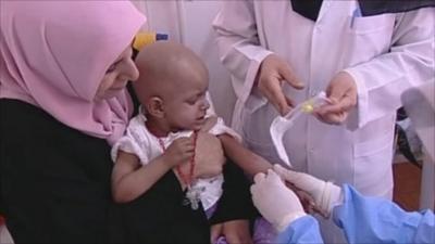 Child being given medical treatment in Benghazi hospital