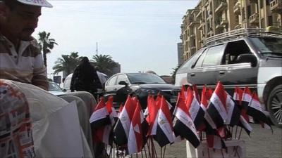 Man selling Egyptian flags on Cairo street