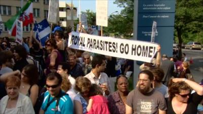 Protesters hold a banner outside the Sainte-Justine Hospital in Montreal