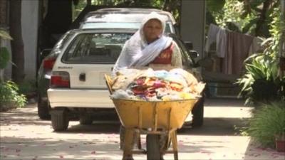 A Christian woman sweeps the streets of Pakistan