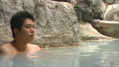 Man sat in a hot spring in Japan