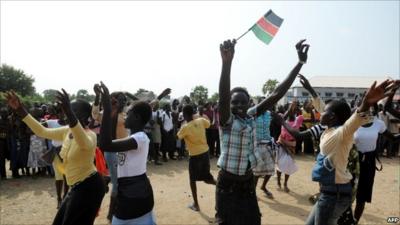 School girl waves South Sudanese flag to celebrate independence