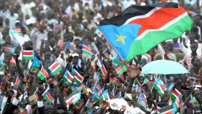 Crowd of South Sudanese people waving their national flag to celebrate independence