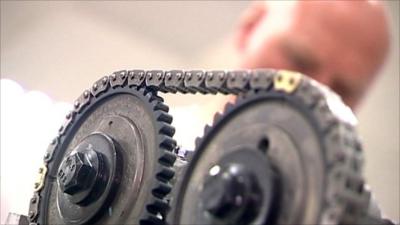 Cogs and chain in engineer's workshop