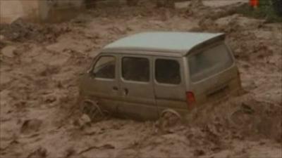 Vehicle swept away by flood water in China