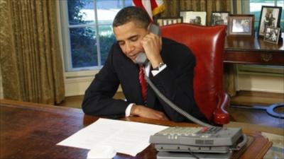 President Obama on the telephone in the Oval Office at the White House