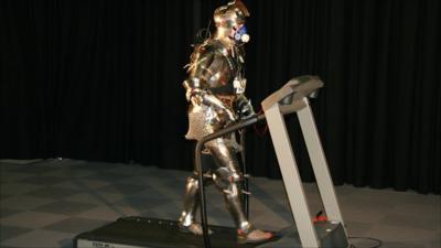 Man on a treadmill wearing medieval armour