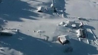 Some houses have almost disappeared under the snow