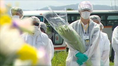 People in prayers for those that died in the Japan earthquake and tsunami