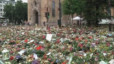 Flowers and candles commemorate the victims