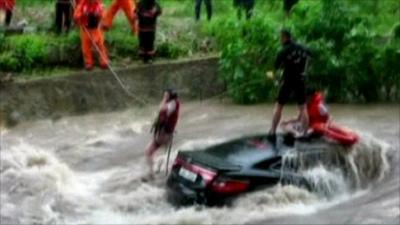 People rescued from a car in the floods