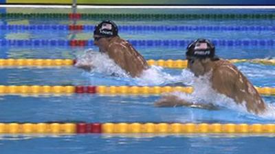 American Ryan Lochte breaks the world record on his way to beating country-man Michael Phelps