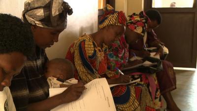 Women wait to be screened for cervical cancer at a health clinic in Rwanda