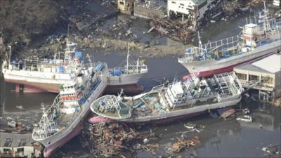 Damaged ships are seen after a tsunami and earthquake in Kesennuma City in Miyagi Prefecture, Japan