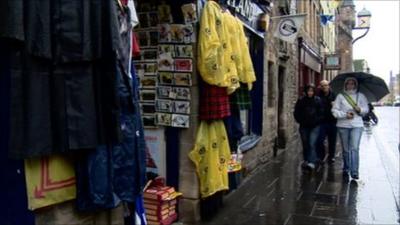 People walking past a shop selling souvenirs