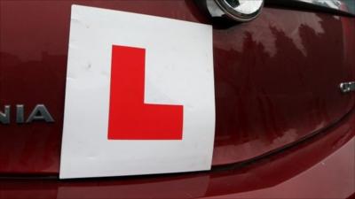 L plate on the back of a car