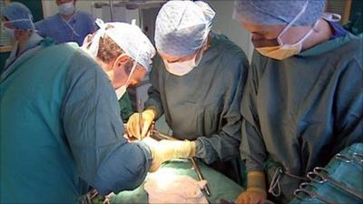 Surgeons operating in a hospital theatre