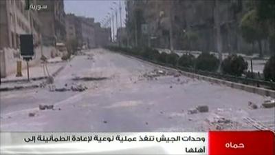 Syrian state TV images of a rubble-strewn street in Hama