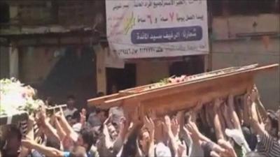 People carry a coffin in Syria