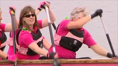 Cancer patients paddle a boat