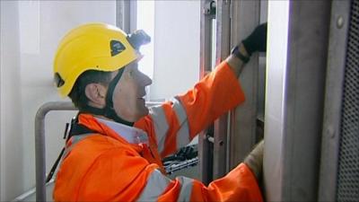 David Shukman climbing a wind turbine