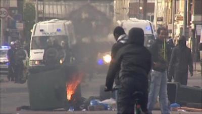 Rioters in front of line of riot police