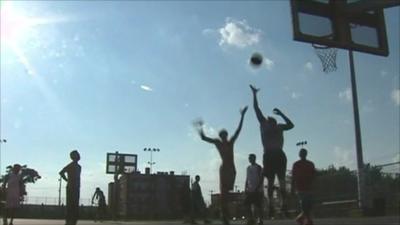 Youths playing basketball at youth centre in Philadelphia