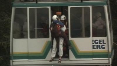 An emergency worker enters the cable car