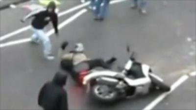 Man pulled from scooter during riots