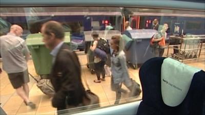 Rory Cellan-Jones walking through Paddington station while viewed through train window