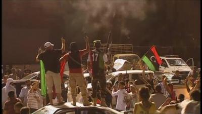 Rebels celebrate having seized Gaddafi compound