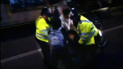 Police and disabled man in London student protests