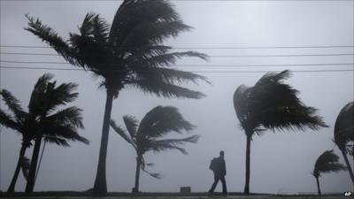 Man walking in the hurricane in the Bahamas