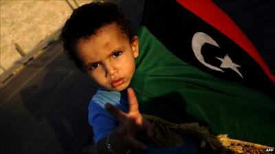 Boy in Tripoli with rebel flag