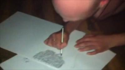 Lee Hadwin producing his artwork