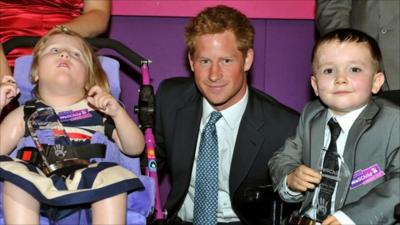 Prince Harry poses with 5-year-old Sophie Cooper (left) from Lincoln and 6-year-old Harley Lane from Stockport