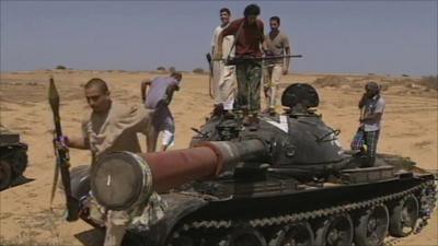 Anti-Gaddafi forces standing on a tank