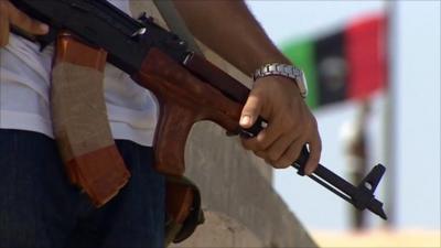 Gun and Libyan flag