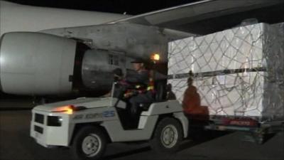 Aid from the US being carried off a plane in North Korea