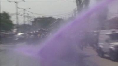 Police use water cannons to spray protesters with purple dye in Srinagar