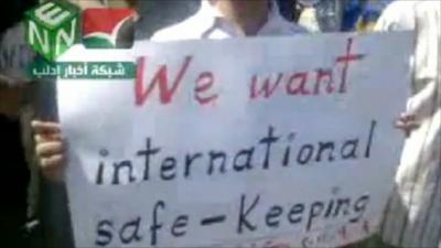 Placard saying "We want international safe-keeping"