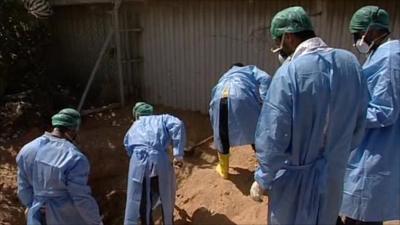 Forensic teams working at one of the roadside graves