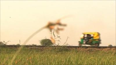 A car driving along a rural Indian road